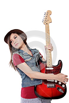 Rocker lady striking cool pose with her guitar, on white bac