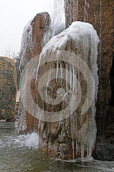 Rockery stone and waterfall in winter