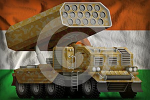 Rocket artillery, missile launcher with sand camouflage on the Niger national flag background. 3d Illustration