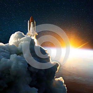 Rocket launch, lift off at amazing sunset. Space shuttle in the space near Earth with yellow sunrise. Clouds and sky on background