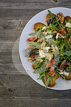 Rocket salad with fig mozzarella roasted bread photo