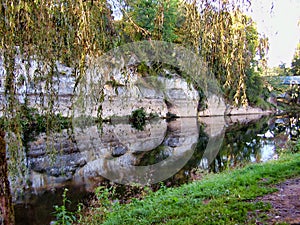 Rockface reflected in the river