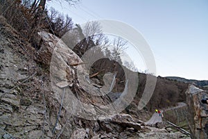 Rockfall net totally destroyed by big boulder photo