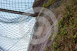 Rockfall protection net on steep hillside for landslide prevention and safety photo