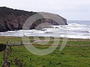 Rocks formation and waves in front photo