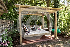 Rocking bed pergola. Garden bed with pillows