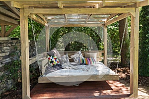 Rocking bed pergola. Garden bed with pillows