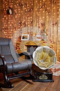 Rocking-chair and gramophone near fireplace in