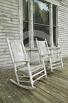Rocking chairs on porch of southern house in disrepair along Highway 22 in Central Georgia