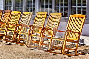 Rocking chairs in a row on an outdoor porch