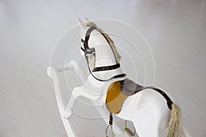 A rocking horse. Children`s toy horse. White toy horse.