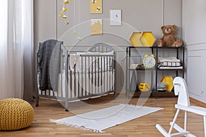 Rocking horse and rug on the floor of trendy baby bedroom