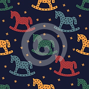 Rocking horse silhouette. Seamless pattern with rocking horses on dark blue background.
