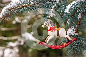 Rocking horse and snowy pine tree decorated for Christmas