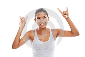 Rocking on with a smile. A young woman in gym clothes gesturing at the camera.