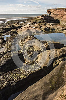 Rockpools and cliff at Hilbre Island, West Kirby, Wirral
