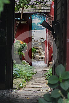 A hidden passage in downtown Rockport, Massachusetts with the harbor in the background.