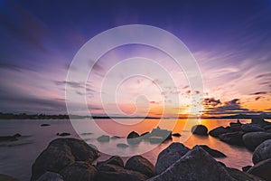 Rocks beach in the evening with sunset sky backgrounds