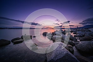 Rocks beach in the evening with sunset sky backgrounds