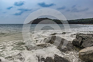 Rocks on the beach facing Waves - Gokarna