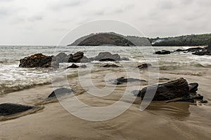 Rocks on the beach facing Waves - Gokarna