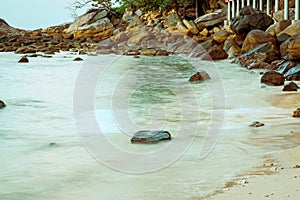 Rocks by the beach in tropical island. Long expsure