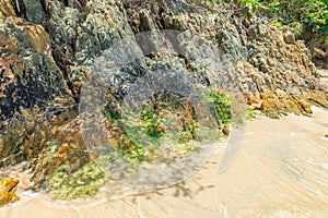 Rocks by the beach with waves splahes