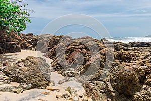 Rocks by the beach with waves splahes