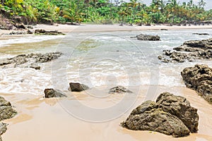 Rocks by the beach with waves splahes