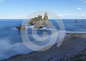 Rocks in the blue waters of the cantabric sea, pendueles beach in Asturias. photo