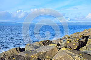 Rocks blurry background yellow stones ocean blue ripples