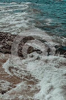 Image of rock formations stones, with texture and sharpness, on the beach during the day photo