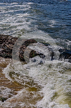 Image of rock formations stones, with texture and sharpness, on the beach during the day photo