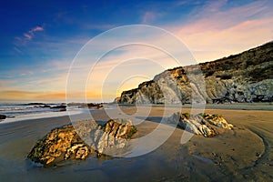 Rocks on Carpinteria Beach at sunrise during low tide. California photo