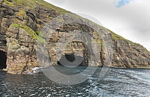 Rocks and caves of the coast on Vágar Island