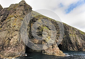 Rocks and caves of the coast on Vágar Island