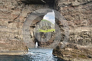 Rocks and caves of the coast on Vágar Island