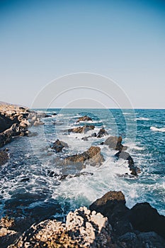 Rocks and cliffs on the beach in Playa de los Muertos, Spain