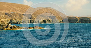 Rocks and Cliffs of town Ajuy in Fuerteventura, Canary Islands, Spain. Azure calm ocean waves. Picteresque spectacular