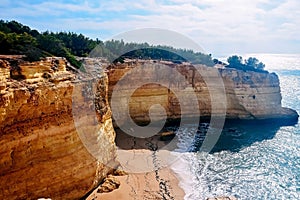 Rocks on the coast of Benagil beach in Lagoa. Top view of the atlantic ocean in portugal