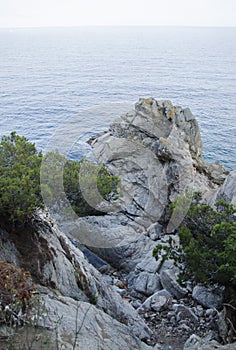 Rocks on the coast of Lloret de Mar in a beautiful summer day, Costa Brava, Catalonia, Spain. Waterfront of Lloret de