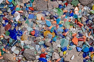 Rocks and colorful glass recycled as ground cover.