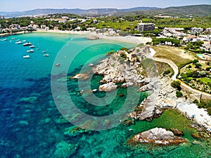 And rocks in crystal-clear blue water near the La Fosca Beach, Palamos, Costa Brava, Spain