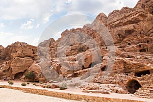 Rocks dotted with the many caves carved by Nabatean craftsmen in Nabatean Kingdom of Petra in the Wadi Musa city in Jordan