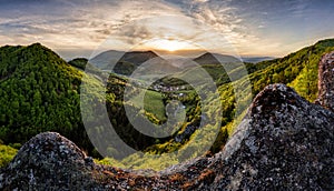 Rocks and forest landscape at dramatic sunset, spring time