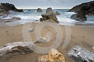 Rocks getting dark in the beach of Miengo photo