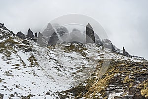 Rocks and grass covered by mist and snow