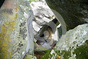 Rocks inside a cave with green moss