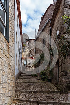 Narrow street of Monsanto vollage with rocks photo