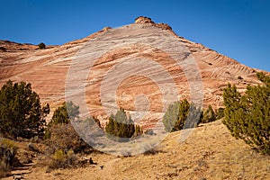 Rocks and Mountains along a trail to Tunnel Slot during sunny day with blue sky in Escalante National Monument, Grand Staircase